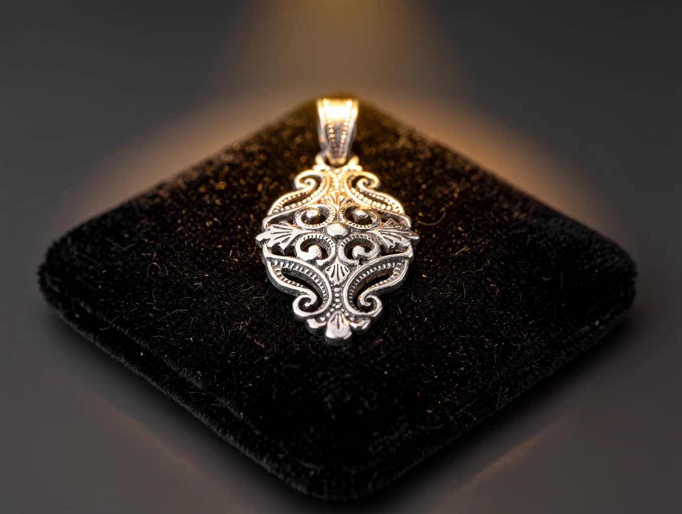 Hand-hammered sterling silver jewelry piece on a slate background